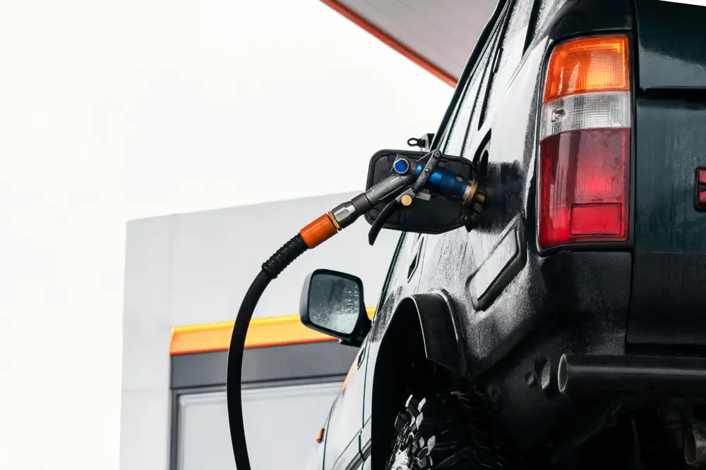 Off-road vehicle refueling with fuel nozzle at gas station