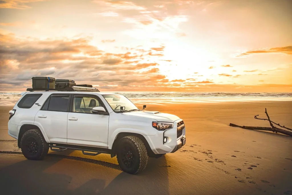 4WD parked on the beach at sunset
