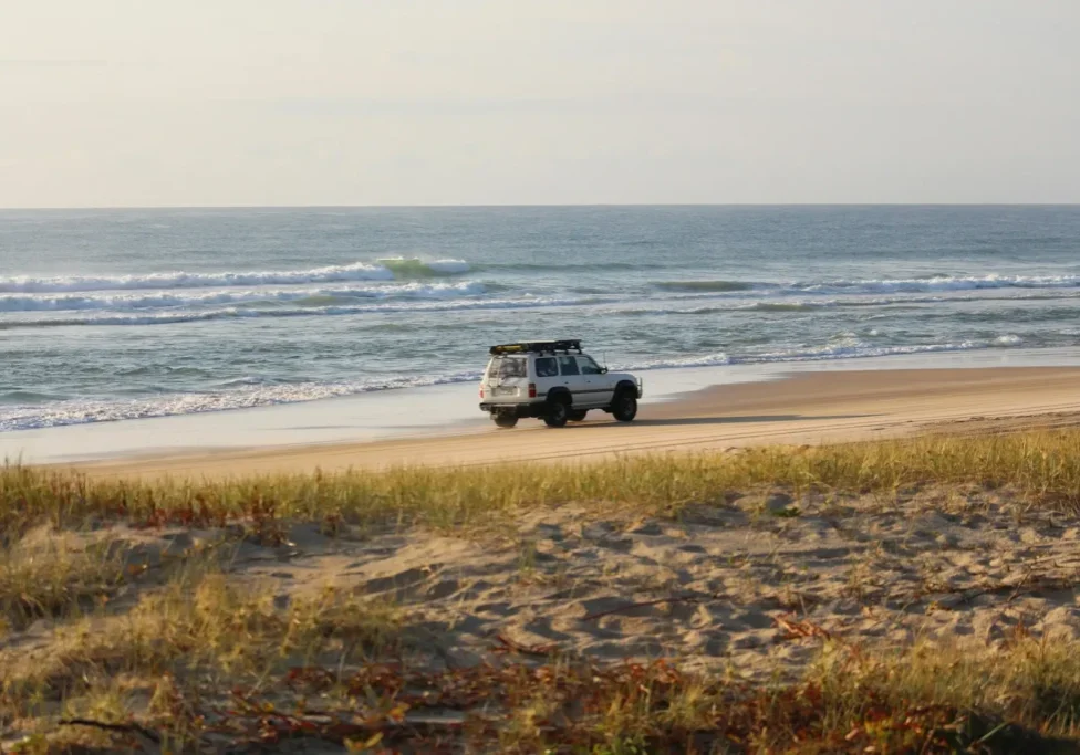 Toyota cruising along the beach in the afternoon